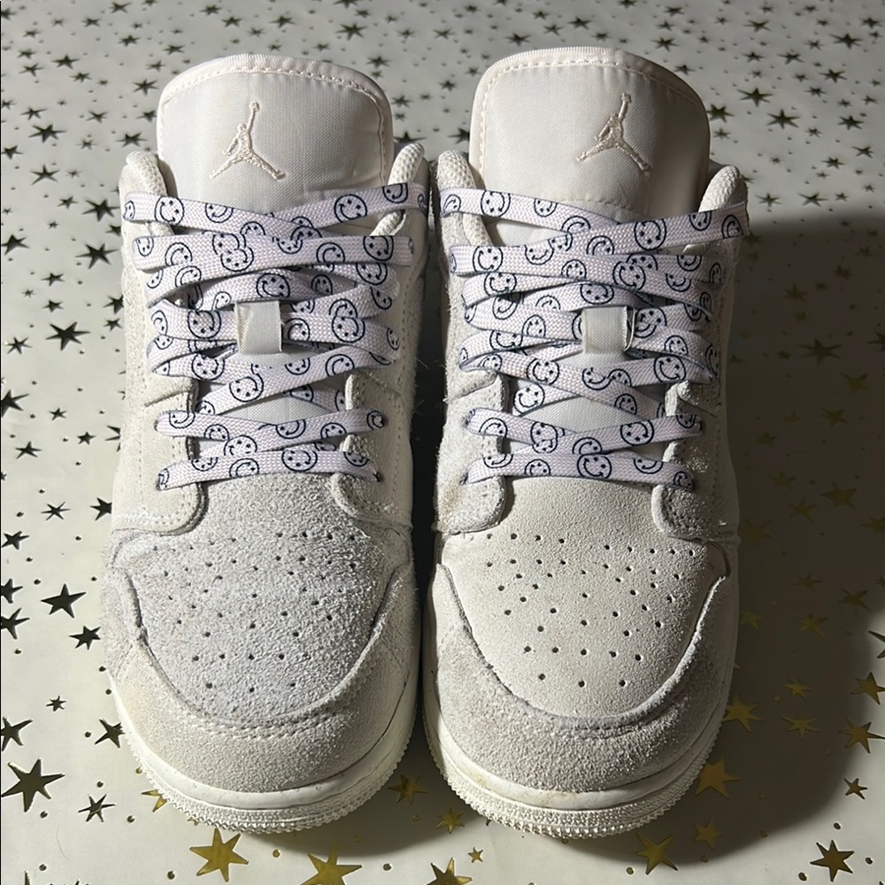 Nike Jordan 1 Low craft series (white) with smiley face shoelaces.